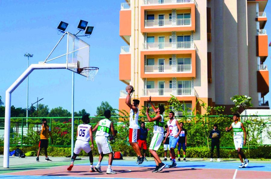 Residents playing basketball on the River Valley Township sports court