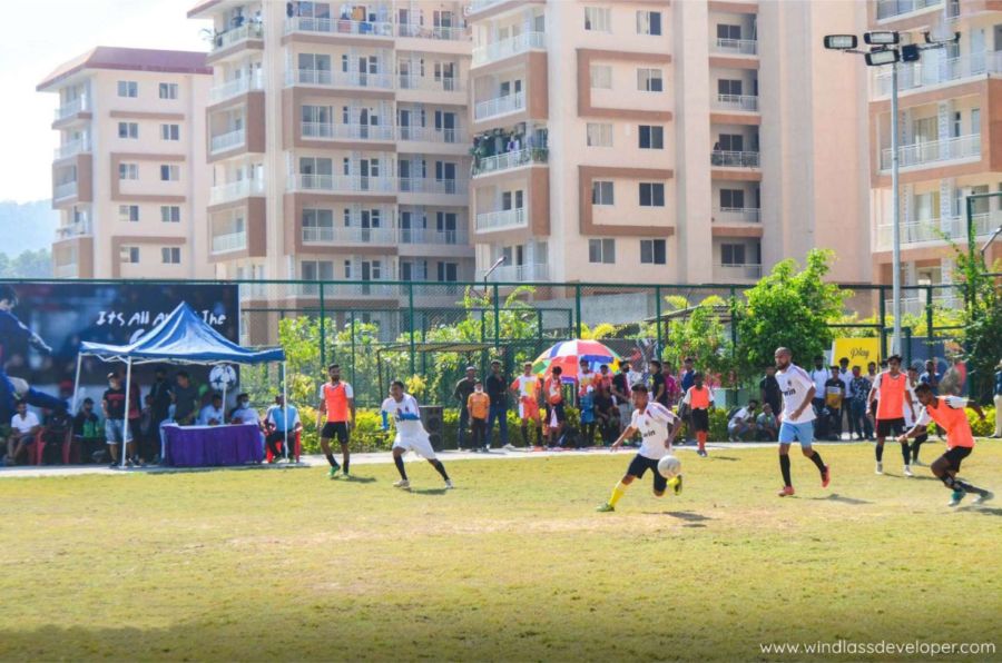 Residents playing a football tournament in front of the towers at River Valley Township