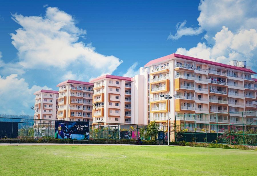 Ganga Towers at River Valley Township, Dehradun: ready-to-move 2 BHK apartment towers beside the township football ground