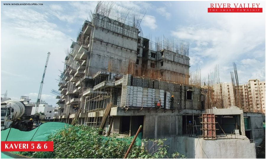 Construction progress at Kaveri Towers 5 and 6, River Valley Township, June 2026: concrete work with a transit mixer on site