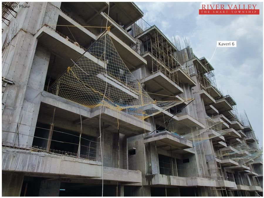 Construction progress at Kaveri Towers 5 and 6, River Valley Township, May 2026: kaveri 6 facade with safety netting